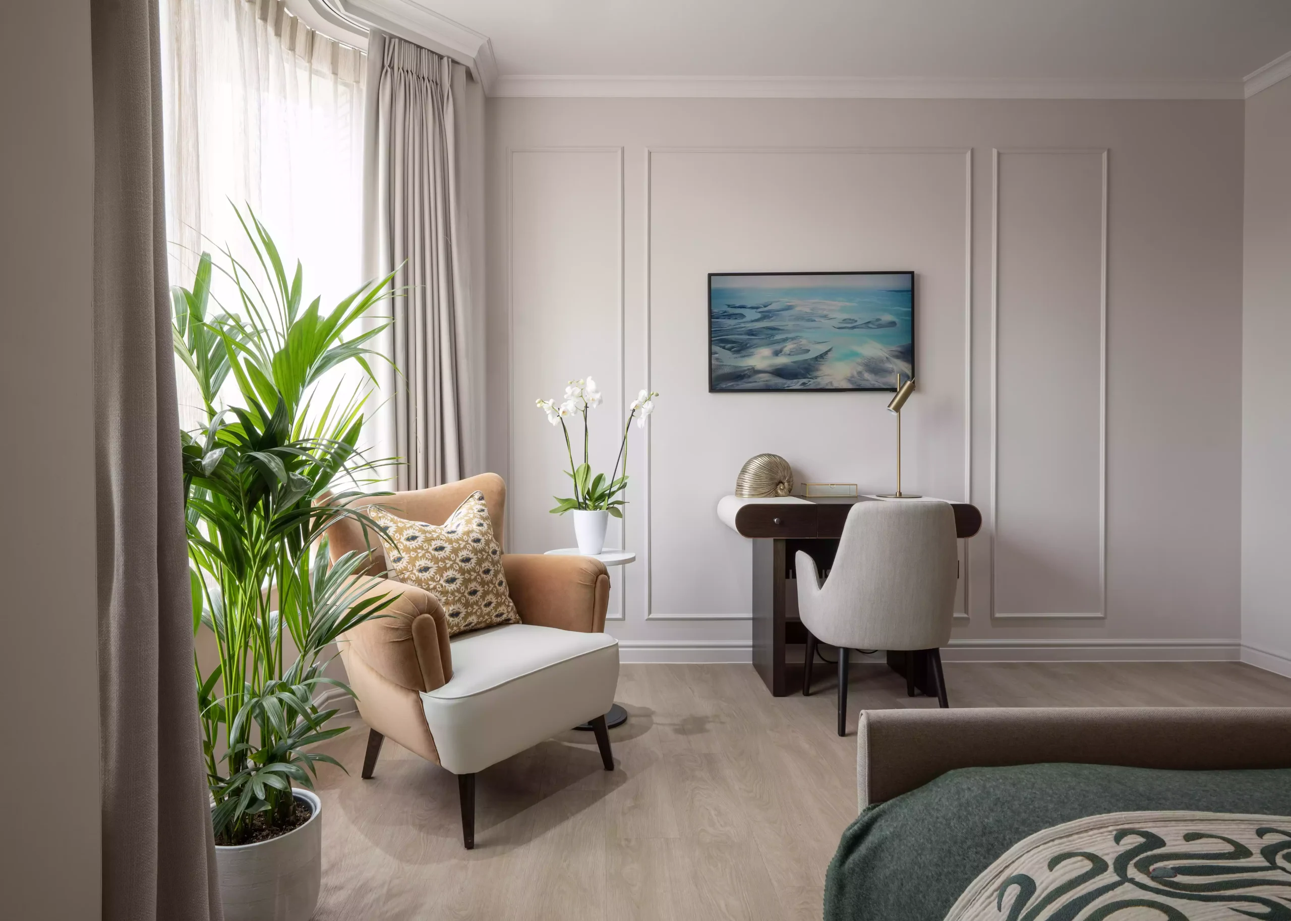 Photo of a luxury room with single sofa and bed in it.