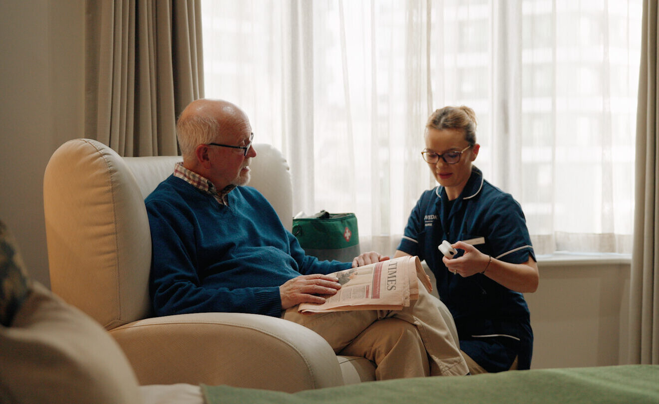 Care home in Belgravia, nurse attending to resident